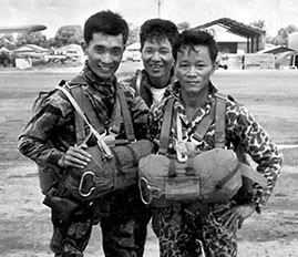 Three members of the Apache Force prior to a parachute jump at Ho Ngoc Tau. The Apache Force was airborne qualified after four hours of training and one training jump from a helicopter.