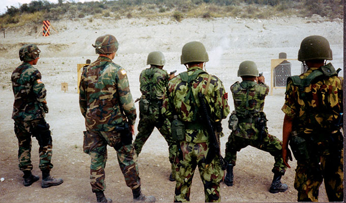 Pistol marksmanship with the U.S. M-1919 .45 caliber pistol. The slightly-built Nepalese soldiers braced themselves for the recoil of the pistol.