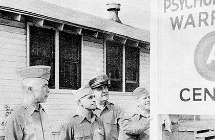 COLs Charles H. Karlstad and Aaron Bank with LTCs Lester L. Holmes and John O. Weaver pose by the Headquarters sign on Smoke Bomb Hill, Fort Bragg, NC.