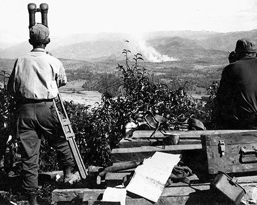 An observer from the 612th FAB calls in artillery on Japanese positions along the Burma Road, 19 January 1945.