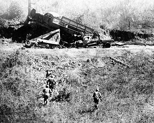 After blowing a large crater in the Burma Road on 19 January 1945, a MARS Task Force patrol returns in daylight to inspect the night’s “catch” of two tankettes and a truck.