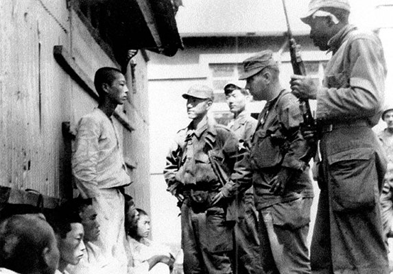 MAJ Jack Young (center) questions NKPA POW in P&rsquo;yongyang.