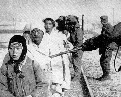 MPs screen refugees for hidden weapons with mine detectors.