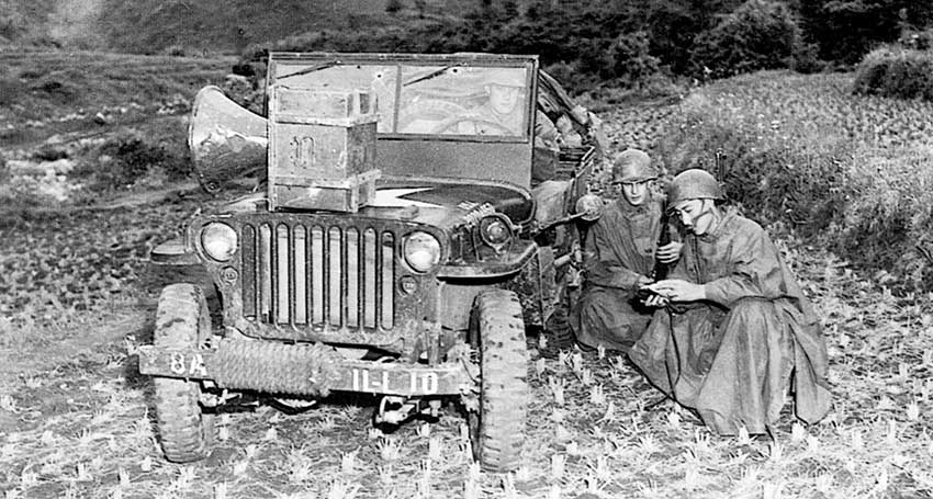 PFC Wilson, SGT Lawrence O&rsquo;Brien, and Yang Yunn (left to right) broadcast to the Chinese near Munye-ri.