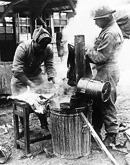 Members of the 2nd Ranger Company clean their equipment. 