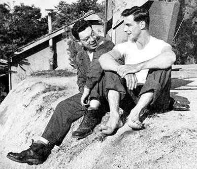SSG Joe Lissberger & CPL Herbert Shevins relax by the water tower used to wash the photographic plates