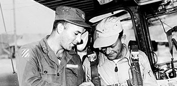 CPT Leonard Kleckner, I Corps Psywar staff officer, briefs L-19 pilot 1LT Albert D. Ackley on a leaflet drop in 1951
