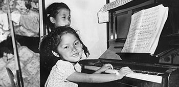 Children from the Bookhan Mountain Orphans Music Academy pose for a contribution poster