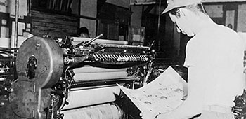 PFC Paul A. Wolgeher checks print run on the Harris Press