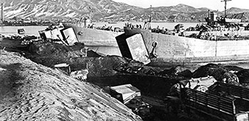 A truck convoy approaches the beach landing sites at Hungnam.