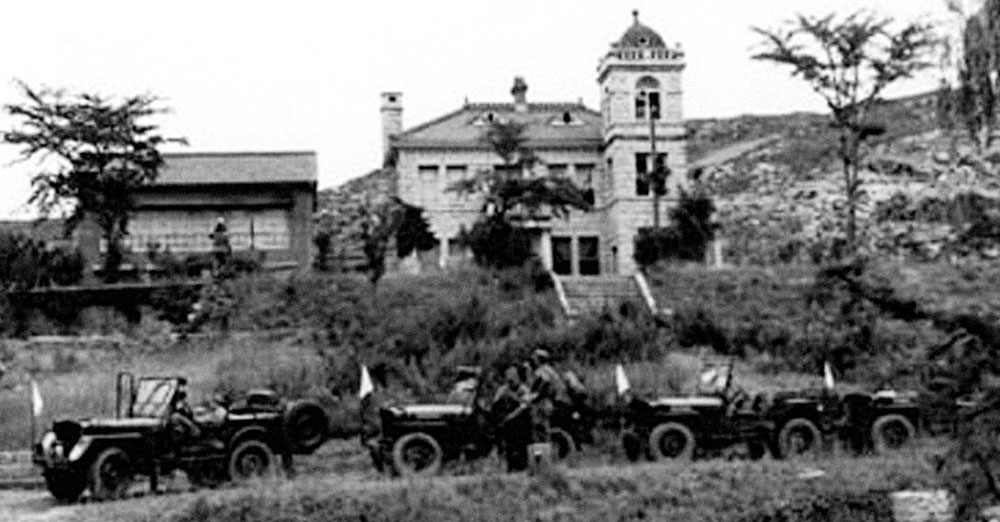 UN vehicles marked with white flags parked below the negotiations site. Communist transportation was parked above to blatantly demonstrate superiority.
