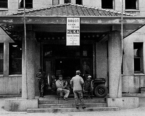 Koreans relax outside Radio Seoul.
