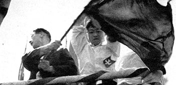 Communist leaders yelling “Banzai!” exhorted the confused crowd to fall in line for a march to the Imperial Palace, three miles away in central Tokyo.