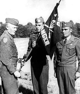 Colonel John G. Van Houten presents the 1st Ranger Infantry Company (Airborne) Guidon to Captain John L. Streigel and Private Joseph Lisi