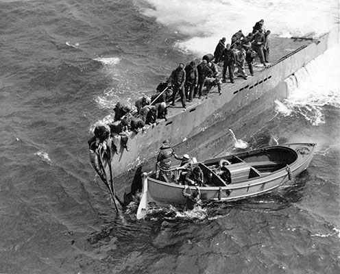 The carrying capacity of the Navy twenty-six foot plywood Mark II motorized whale boat (MWB) was limited. The coxswain normally stood to steer the craft. It is easy to understand why the coxswains were eager to break contact and get beyond small arms range.