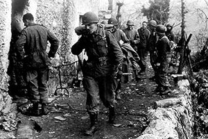 Colonel Frederick leads the FSSF command section out of the village of Radicosa. Controlling operations in the mountains was difficult because mountain fighting was often conducted by squads and sections acting independently.