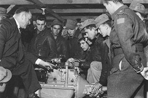 A representative from the Studebaker Corporation gives maintenance instruction to American and Canadian Service Battalion personnel on the T-24 Weasel.