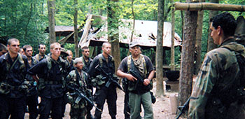 Adderly as a ‘G Chief,’ he and his band of guerrillas meet with a SF advisor before an upcoming mission.