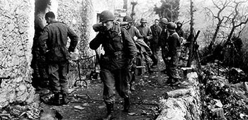 Colonel Frederick leads the FSSF command section out of the village of Radicosa. Controlling operations in the mountains was difficult because mountain fighting was often conducted by squads and sections acting independently.