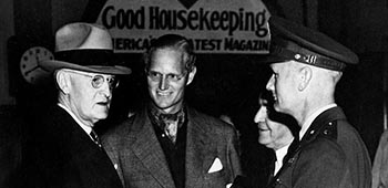 MG Hilldring, in uniform on the right, talking to President Harry S. Truman, left.