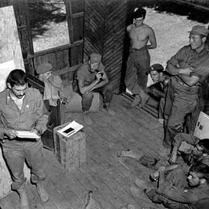 OSS OG/MU team receiving a briefing for a mission off the Arakan Coast of Burma.